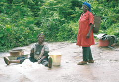 Women processing cassava on a rock outcrop 1.5 km out of their homes. Dust is a big problem in the dry season, and many women travel 1-2 km from the road to process cassava on rock outcrops and riverbanks.