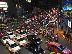 Rush hour traffic blocks the road preventing vehicles from moving forward on a green light at Asok intersection