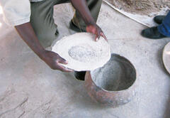 Millet, the staple local crop, is milled by hand.