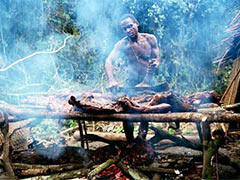 Baka pygmy man smoking bushmeat