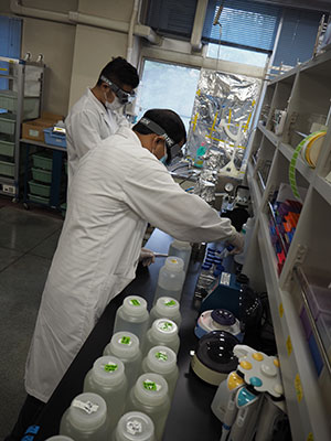 Researchers Bikash Malla and Ocean Thakali filtering the water samples