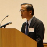 写真：当日の様子「開会挨拶（藤吉尚之審議官）」